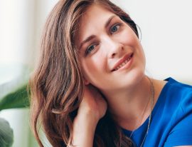 attractive-young-woman-sitting-at-a-table-P7FWDED.jpg